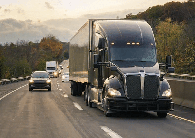 semi truck driving on a road